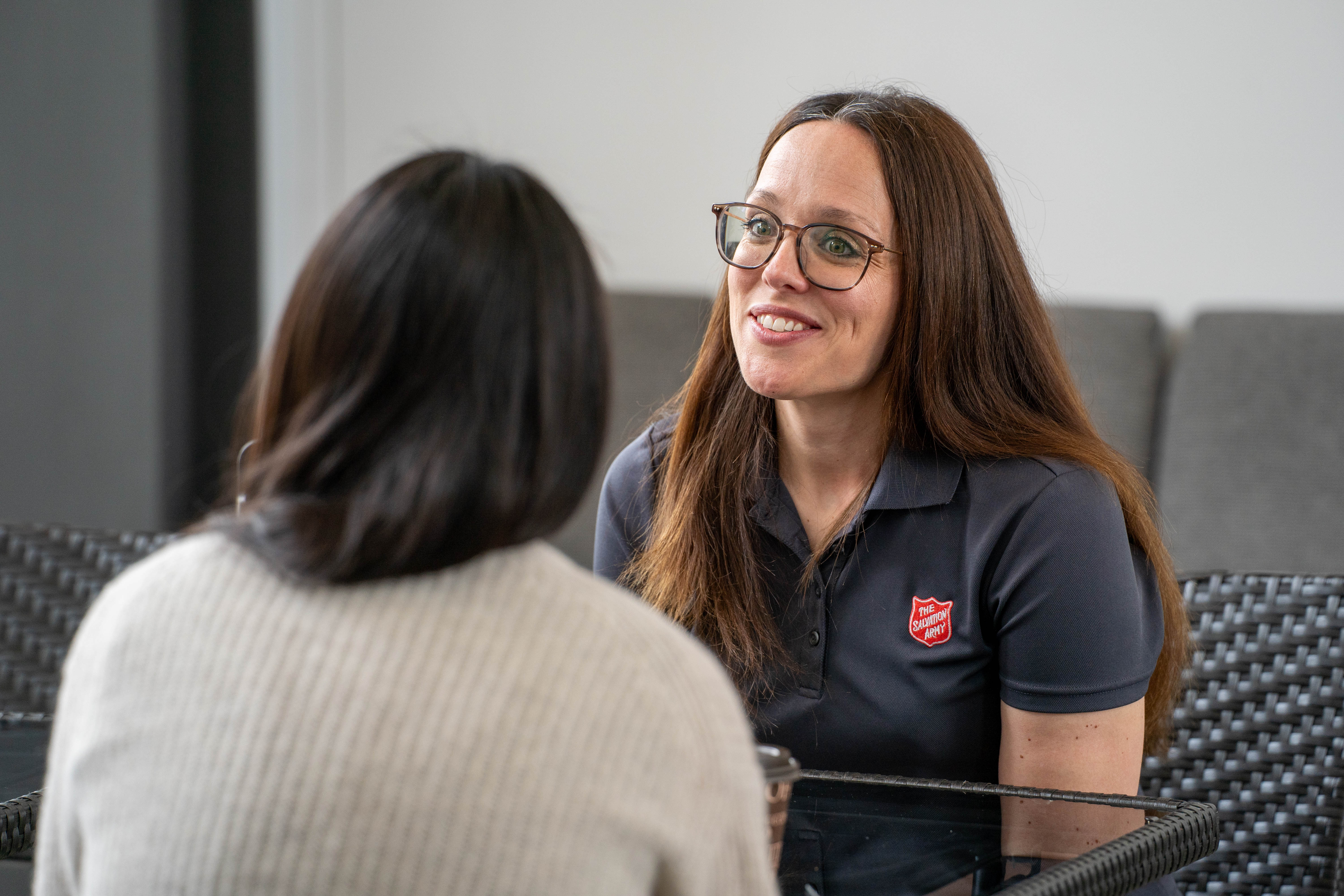 The Salvation Army staff member speaking with a visitor during an in-person donation.