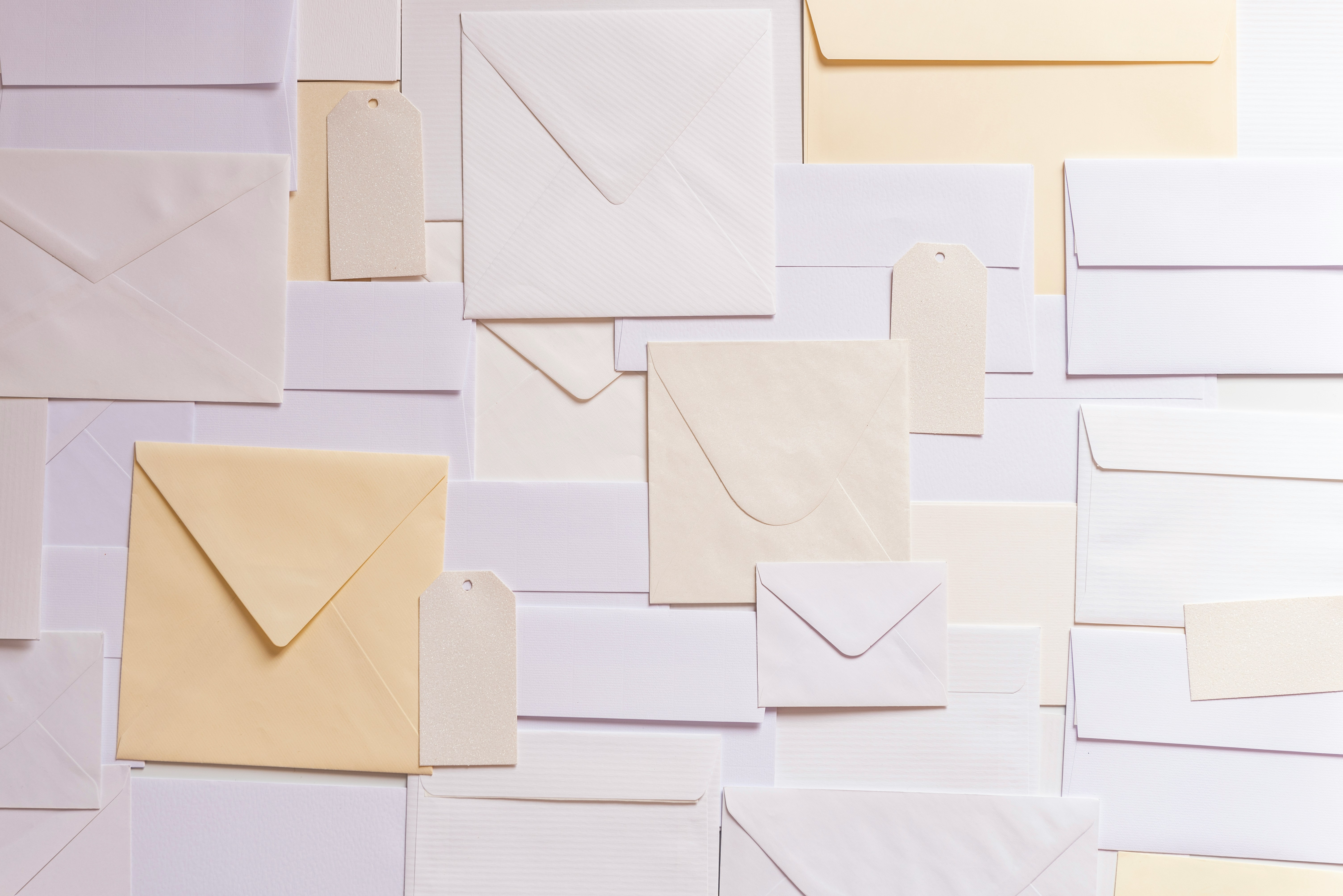 Stack of envelopes representing mail-in cheque or cash donations.