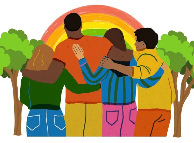 Diverse group hugging each other facing a rainbow in a demonstration of mutual support.