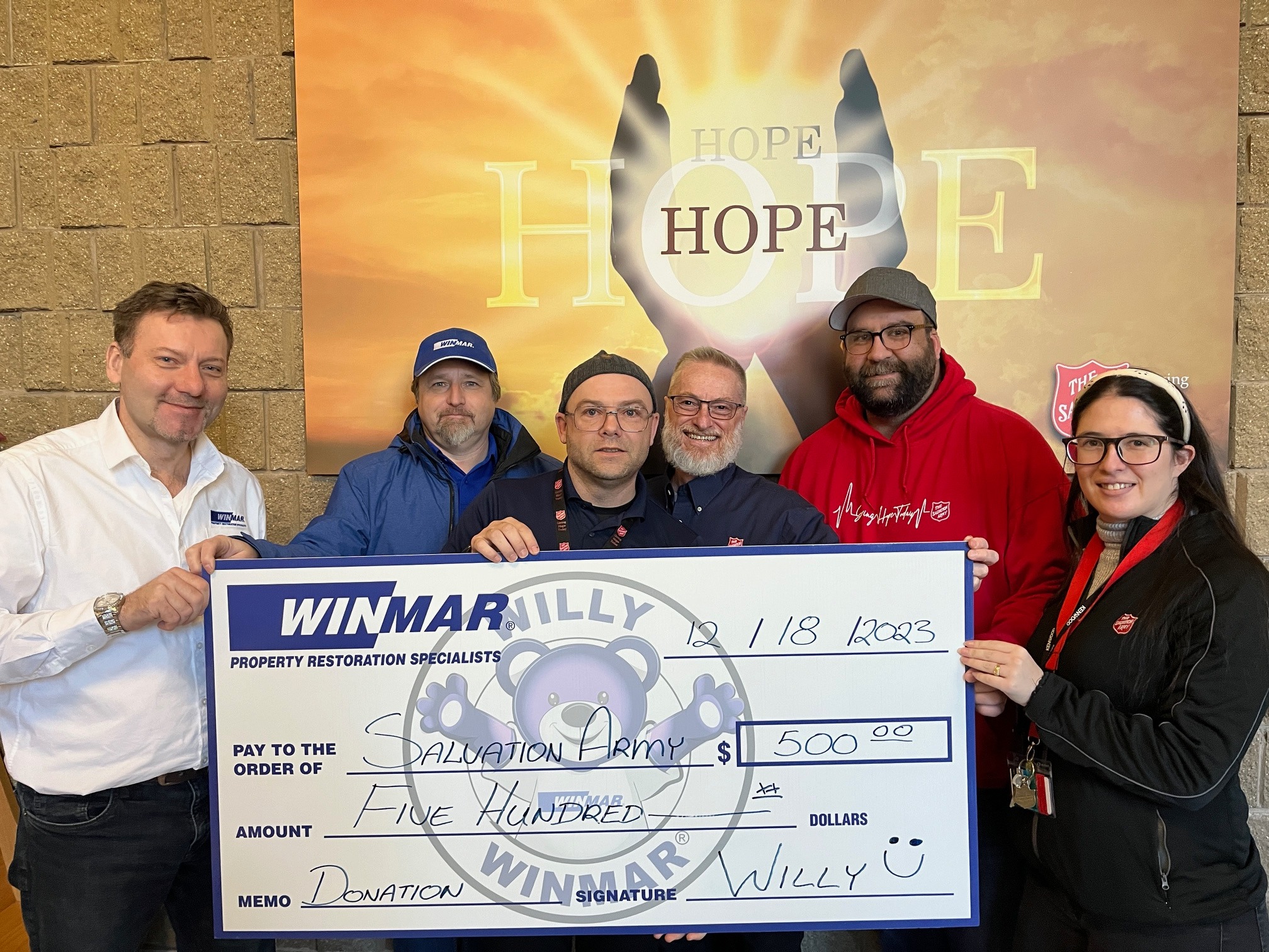 image showing a group of donors and some members of staff from WCOH holding a big cheque