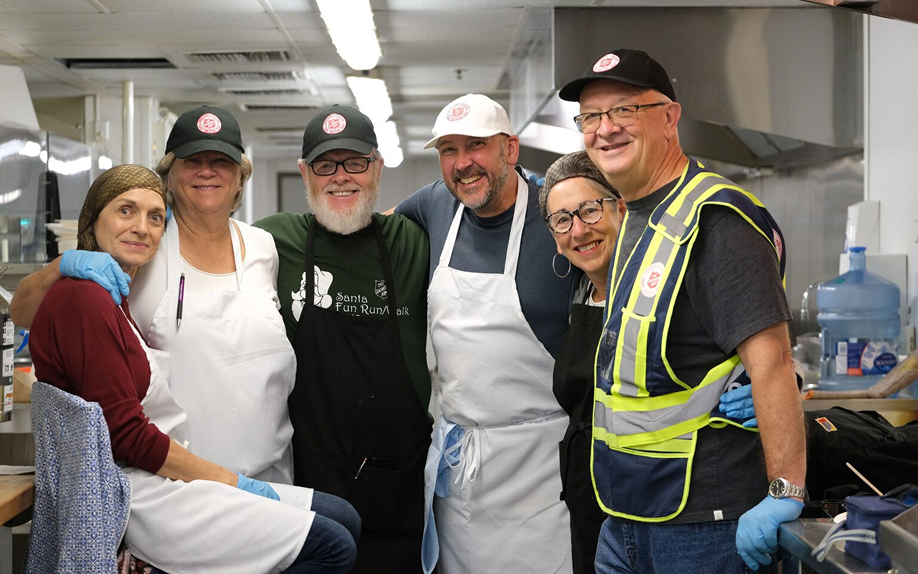 Volunteers and students smiling